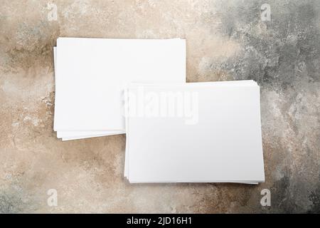 stack of white business card sheet of paper a4 stack on grunge table. Stock Photo