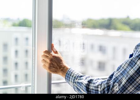 Mosquito Net Frame Install Service. Worker At Home Stock Photo