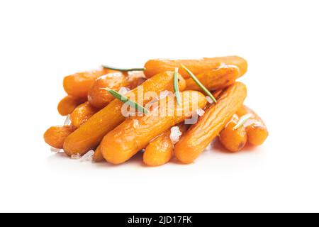 Roasted baby carrots with salt and rosemary isolated on a white background. Stock Photo