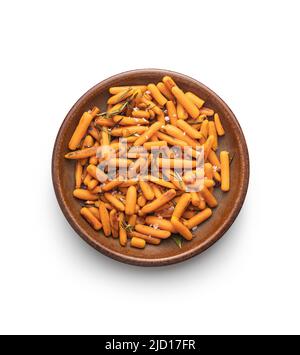 Roasted baby carrots with salt and rosemary isolated on a white background. Stock Photo