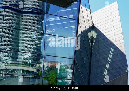 Reflections of the BMW tower and the surroundings in the glass facade of BMW World Munich, Germany, 15.5.22 Stock Photo