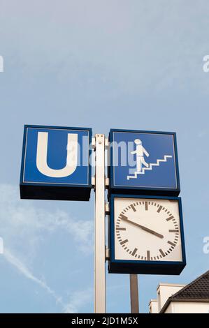 Underground sign, clock and staircase notice, Munich, Bavaria, Germany Stock Photo