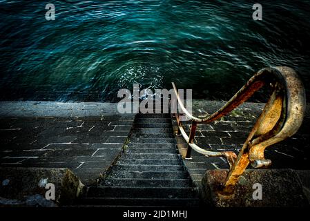 Stairs leading into the sea water. Scary atmosphere. Cold atmosphere. Place for text Stock Photo