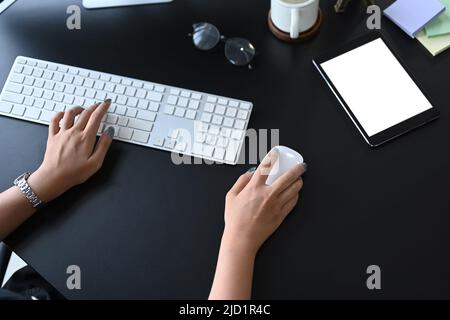 Overhead view businesswoman hand typing on keyboard, working at modern workplace Stock Photo