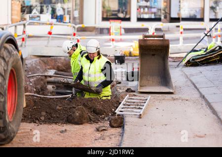Workers in reflective clothing during work Stock Photo
