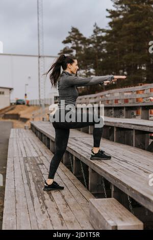 Woman exercising outdoors Stock Photo
