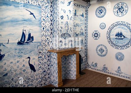 Enkhuizen, Netherlands, June 2022.An interior made of Delft blue wallpaper in the open air museum in Enkhuizen. High quality photo. Selective focus.
