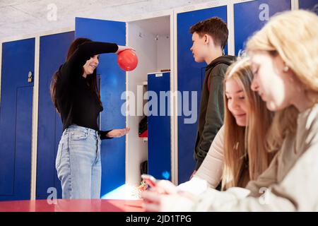 Teenagers in locker room Stock Photo