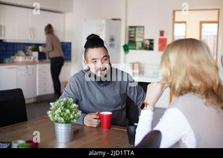 Co-workers talking during coffee break Stock Photo