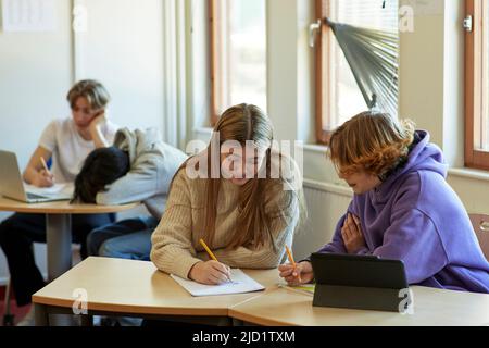 Group of students taking notes in class Stock Photo