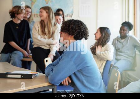Group of students talking in class Stock Photo