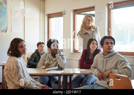 Group of students and teacher in class Stock Photo