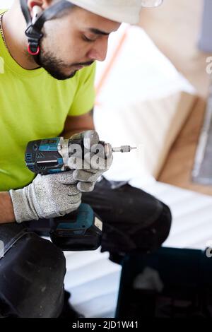 Male worker using drill Stock Photo