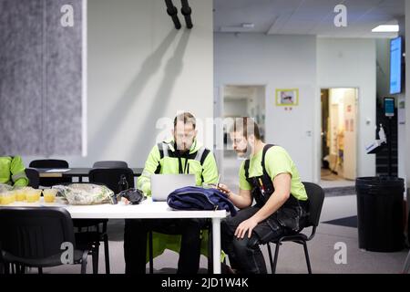 Workers in the canteen using laptop Stock Photo