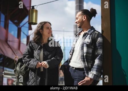 Smiling man and woman standing outdoors Stock Photo