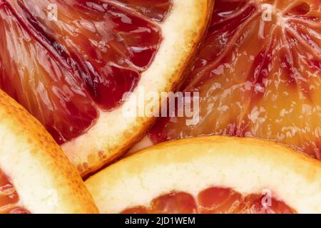 Abstract background with fruit of orange slices. Pattern of orange red citruses. Extreme close-up Stock Photo