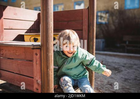 Boy having fun on playground Stock Photo