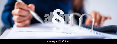 Close-up Of A Red Paragraph Symbol In Front Of Person Working At Workplace Stock Photo