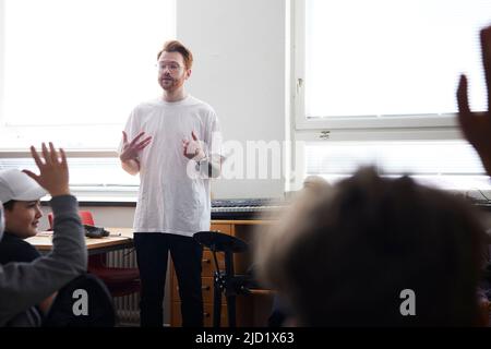 Male teacher and students in classroom Stock Photo