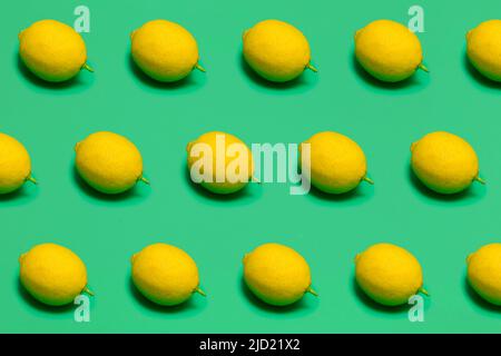 fresh lemons on green plastic surface, seamless pattern Stock Photo