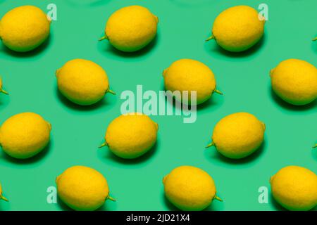fresh lemons on green plastic surface, seamless pattern Stock Photo