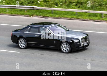 2011 black silver British ROLLS ROYCE GHOST BV12 SWB 6592 cc petrol 8 speed automatic; luxury saloon driving on the M6 Motorway, Manchester, UK Stock Photo