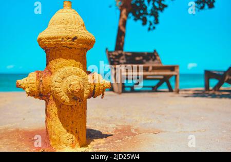 Old yellow fire hydrant on La Punta beach, Los Caracas, La Guaira Venezuela. Concept summer Stock Photo