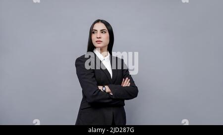 Business women standing and posing with cross hands in style young model Stock Photo