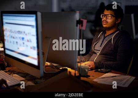 Working on a new game. Cropped shot of a young programmer focused on his work. Stock Photo