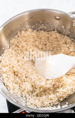 Hispanic Rice Cooking Pot Cooking Mexican rice in a stainless steel cooking pot Stock Photo - Alamy