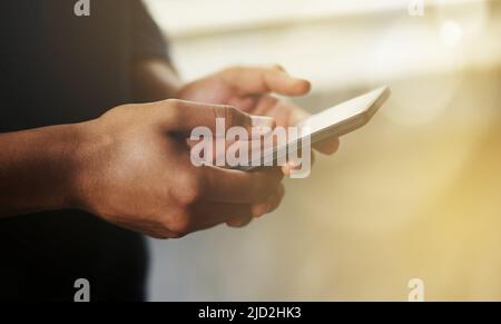 Textingthe faster way of reaching the people that matter. Cropped shot of a man using a smartphone. Stock Photo