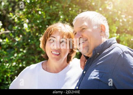 Retired Senior Couple Together In Green Outside Stock Photo