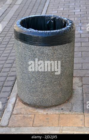 Concrete dustbin on brick pavement, Braamfontein, Johannesburg, Gauteng, South Africa. Stock Photo
