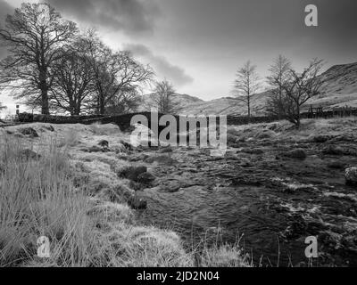 Cockley Beck Bridge over the River Duddon with Harter Fell beyond in the Lake District National Park, Cumbria, England. Stock Photo