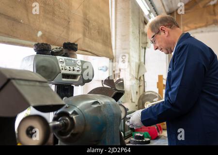 The Earl of Wessex polishing a Commonwealth Games medal during a visit to Toye, Kenning and Spencer in Birmingham. Picture date: Friday June 17, 2022. Stock Photo