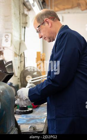 The Earl of Wessex polishing a Commonwealth Games medal during a visit to Toye, Kenning and Spencer in Birmingham. Picture date: Friday June 17, 2022. Stock Photo