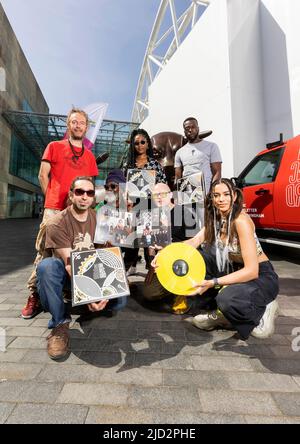 EDITORIAL USE ONLY (left to right) Friendly Fire Band members Bongo Damo, Robi Don and Tomlin Mystic, Sanity, Bambi Bains (kneeling) and Dapz on the Map with producer Jez Collins (centre) at the Bullring in Birmingham, to mark the release of 'On Record', a concept album specially produced and commissioned by Birmingham Music Archive for the Birmingham 2022 Festival. Picture date: Friday June 17, 2022. Stock Photo