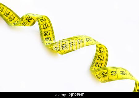 Spiral of yellow and black measuring tape isolated on white background close-up Stock Photo