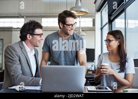 Getting a fresh perspective. Cropped shot of three businesspeople discussing work in the office. Stock Photo