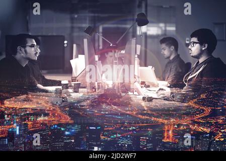Getting the job done 247. Mutiple exposure shot of developers working late superimposed on a urban skyline at night. Stock Photo