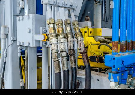 Part of production equipment. Hoses, pipes. Part of machine for production of paving stones. Close-up. Stock Photo