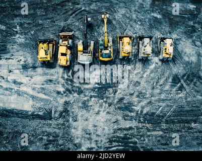 Aerial photo of excavator on industrial place. Construction site top view. Shooting from the drone. Stock Photo