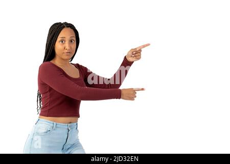 Young black woman with casual clothing in white background pointing to the right Stock Photo