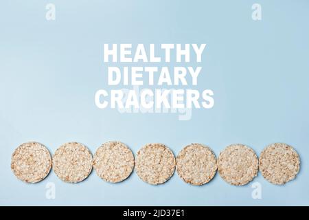 Dietary Crackers text on blue background. Healthy Rise cakes Stock Photo