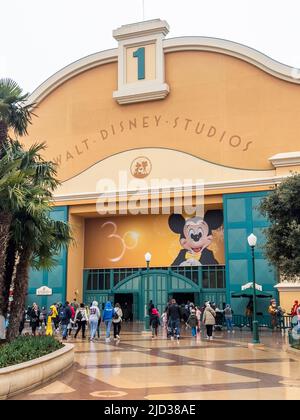 Paris, France - 04/05/2022: Walt Disney Studios in Disneyland Paris at cloudy and rainy weather. People walking around and entering the door. Stock Photo