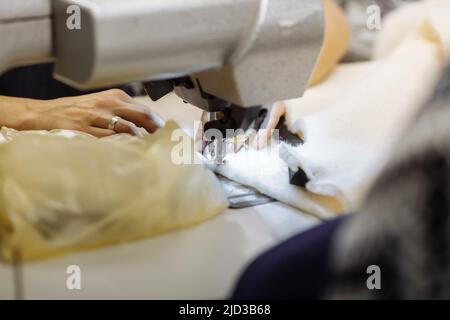 sewing machine scribbling fabric. tailoring at the factory Stock Photo