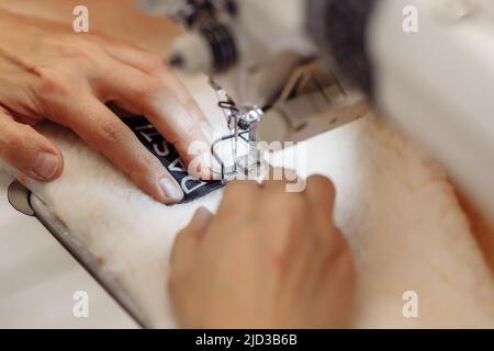 sewing machine scribbling fabric. tailoring at the factory Stock Photo