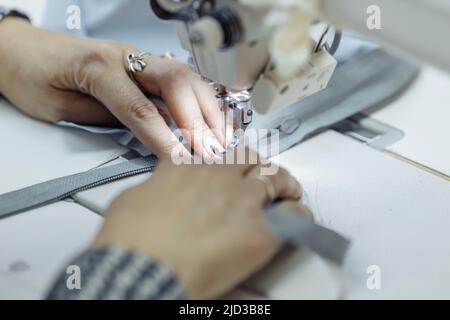 sewing machine scribbling fabric. tailoring at the factory Stock Photo