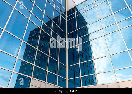 Glass building with mirrored windows. Skyscraper. Line pattern, perspective, steel structure, urban abstraction. Geometric shape, modern exterior, wal Stock Photo