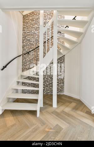 White minimalistic modern spiral staircase and parquet floor Stock Photo